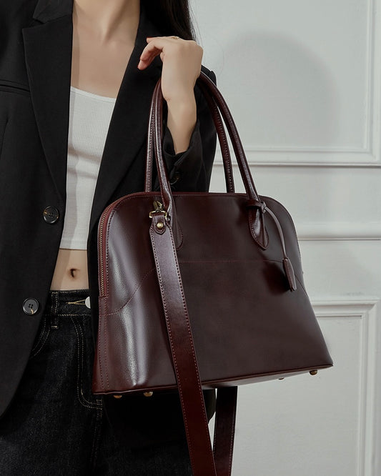 Bolso de mano tipo cúpula para mujer de cuero genuino con borla característica