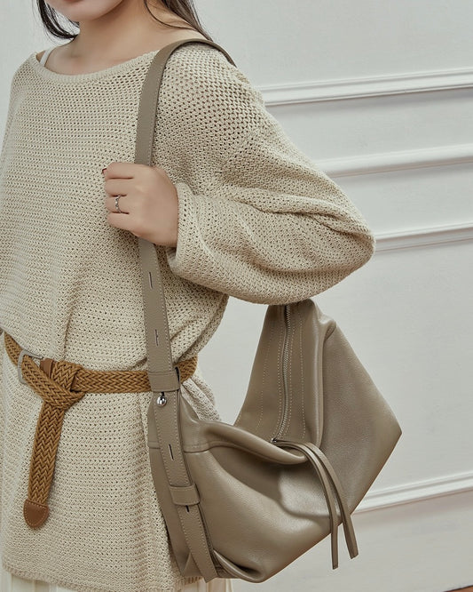 Bolso creciente de cuero genuino granuloso para mujer con adorno de borla