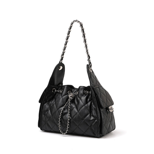 Black quilted handbag with a chain detail on a white background