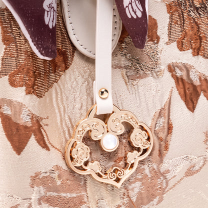 Borsa pochette floreale in jacquard di lusso discreto, in ecopelle vegana, con charm a foulard di seta