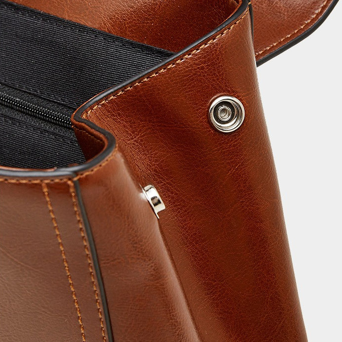 The Oil-Waxed Genuine Leather Convertible Flap Backpack Shoulder Bag