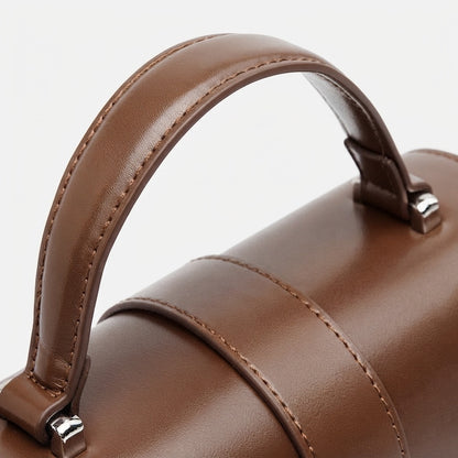 Bolso de mano tipo clutch cilíndrico de cuero genuino con estilo chic  