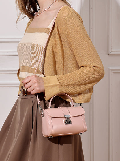 Bolso de mano tipo clutch cilíndrico de cuero genuino con estilo chic  