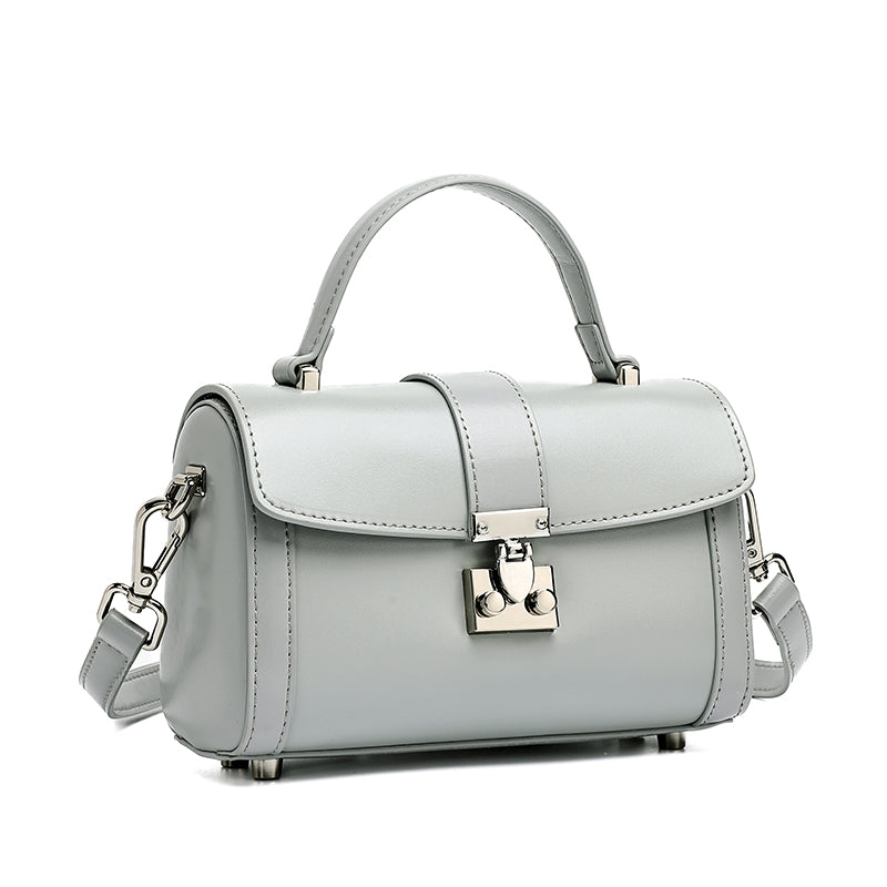 Bolso de mano tipo clutch cilíndrico de cuero genuino con estilo chic  