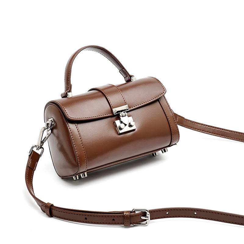 Bolso de mano tipo clutch cilíndrico de cuero genuino con estilo chic  
