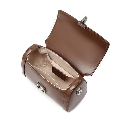 Bolso de mano tipo clutch cilíndrico de cuero genuino con estilo chic  