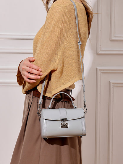 Bolso de mano tipo clutch cilíndrico de cuero genuino con estilo chic  