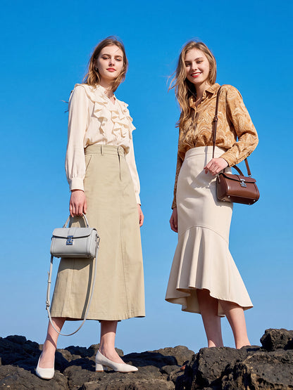Bolso de mano tipo clutch cilíndrico de cuero genuino con estilo chic  