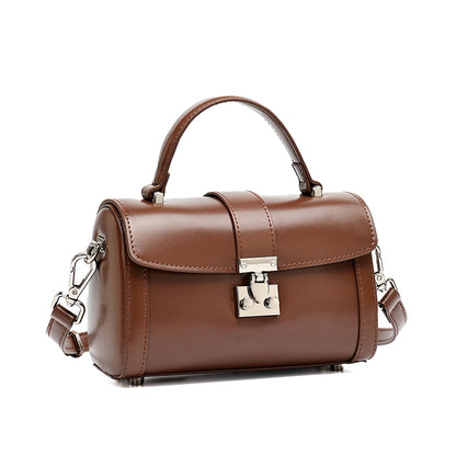 Bolso de mano tipo clutch cilíndrico de cuero genuino con estilo chic  