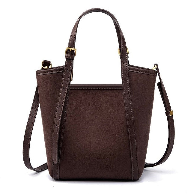 Brown leather handbag with a shoulder strap on a white background