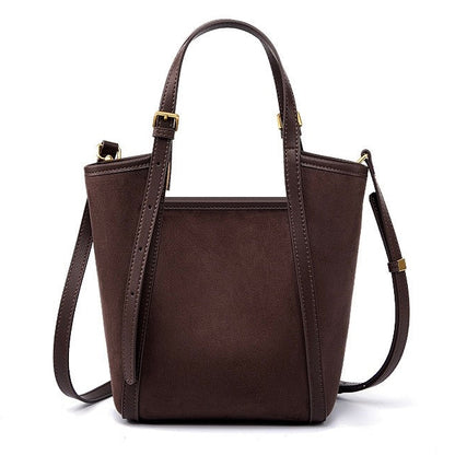 Brown leather handbag with a shoulder strap on a white background