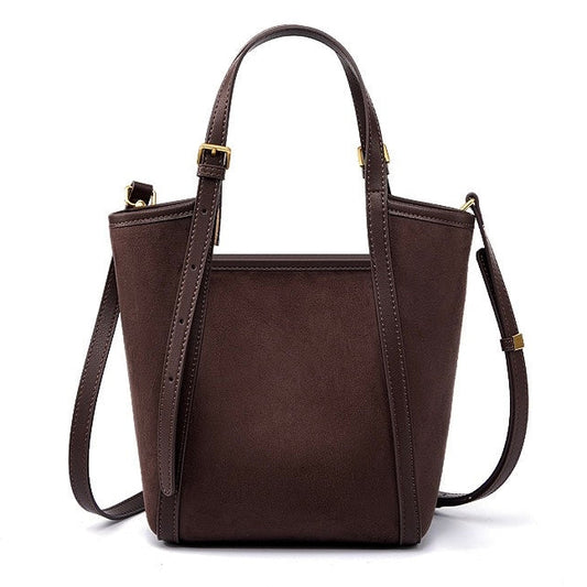 Brown leather handbag with a shoulder strap on a white background
