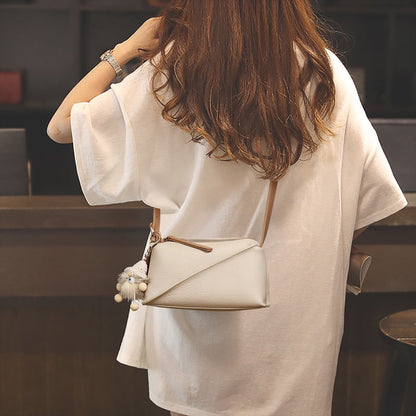 Elegant Geometric Genuine Leather Crossbody Bag with Plush Charm