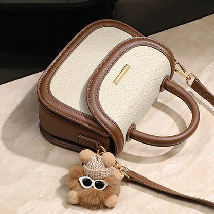 Damen-Handtasche aus echtem Leder mit Farbblock und pelzigem Anhänger