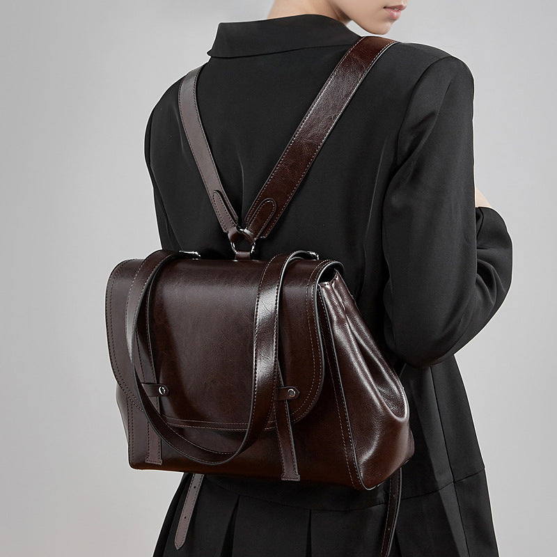 The Oil-Waxed Genuine Leather Convertible Flap Backpack Shoulder Bag