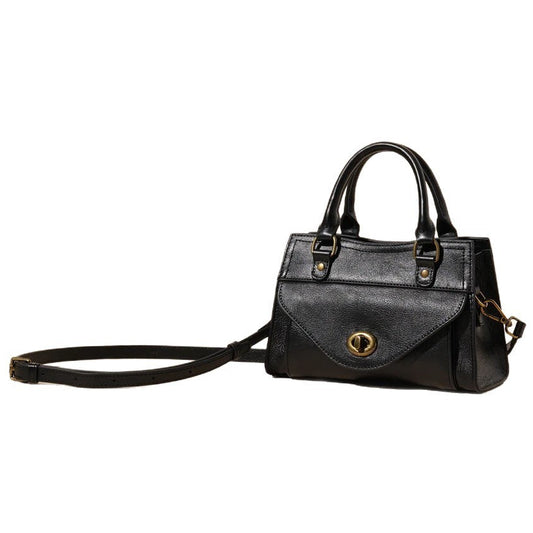 Black handbag with gold accents on a white background