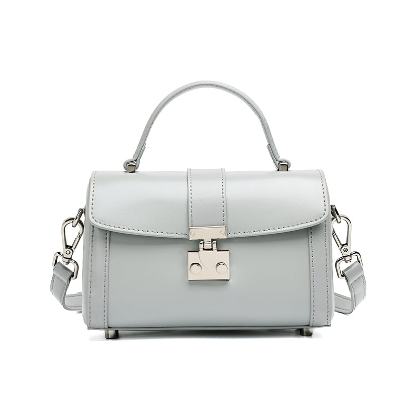 Bolso de mano tipo clutch cilíndrico de cuero genuino con estilo chic  