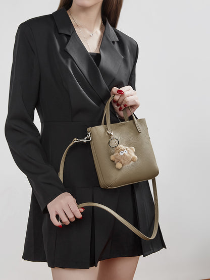 Borsa testurizzata a secchiello, a spalla e tracolla, in vera pelle martellata con dettaglio giocoso