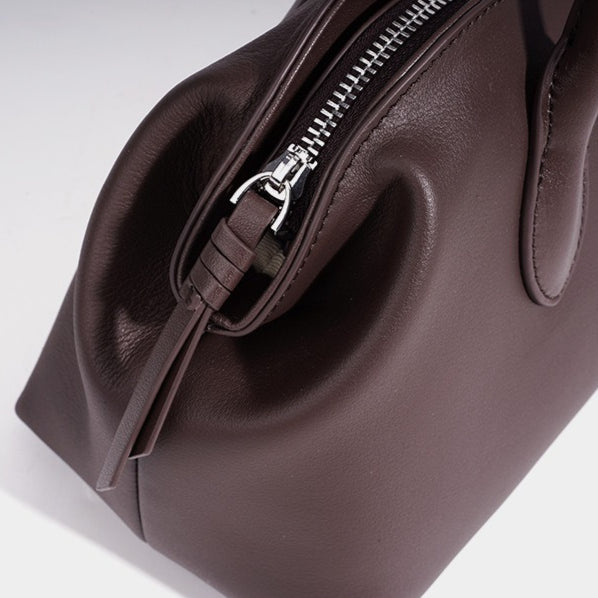 Minimalist Supple Genuine Leather Curved Clutch Bag with Playful Charm